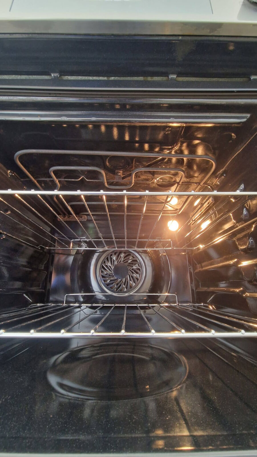 The same fan oven after a professional clean by Mr Green Oven Clean, with spotless enamel, racks and fan